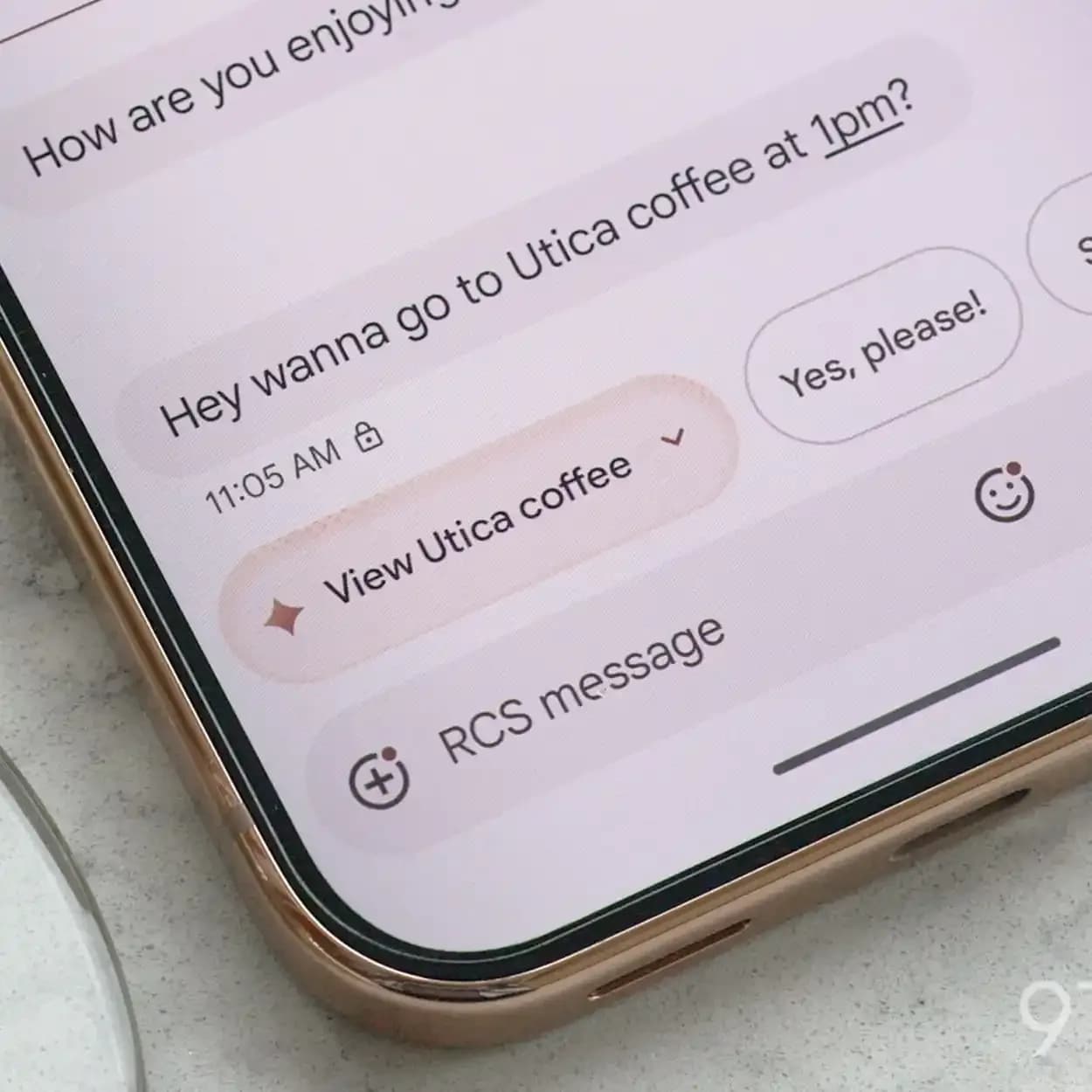 Pixel 11 Pro showing a Gemini intelligence suggestion chip in Google Messages offering to view a coffee shop mentioned in the conversation